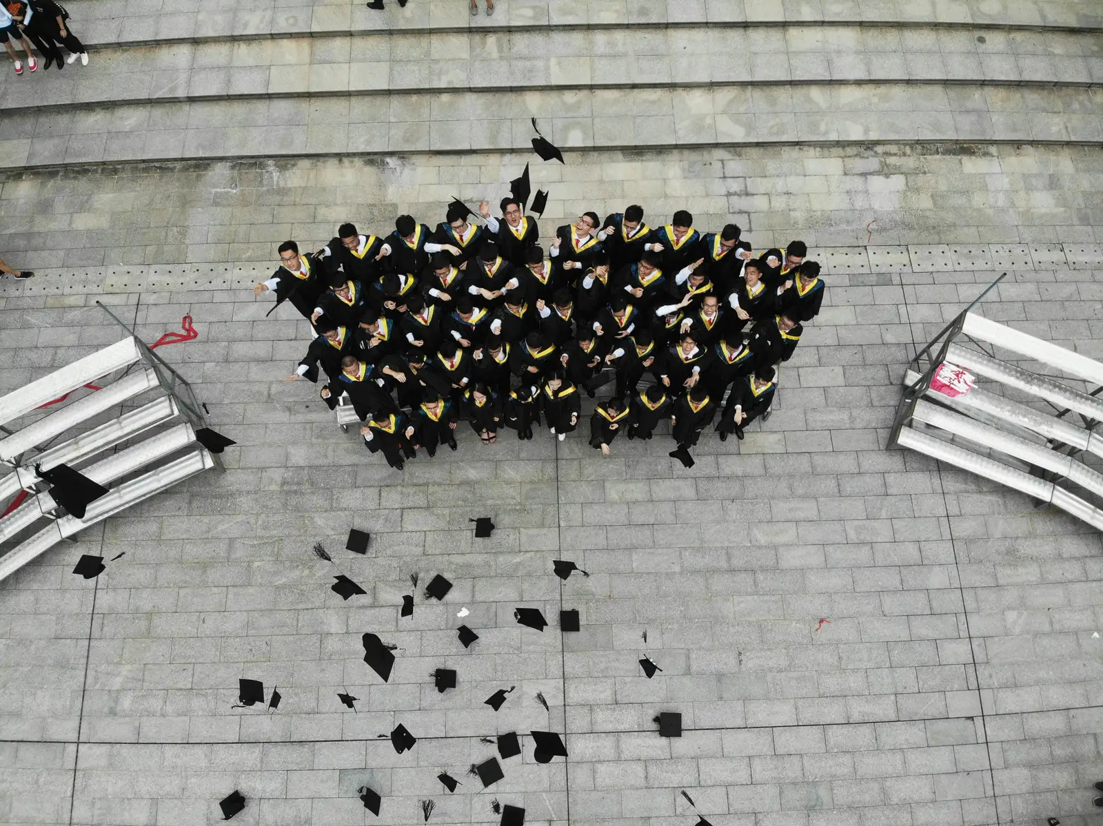 Graduates celebrating on a university campus, seen from above